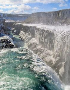 the water is crystal blue and green in this view looking down on niagara falls, canada