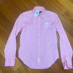 Womans Ralph Lauren Sport Shirt Nwt. This Shirt Is A Size 10 Color Is Pink Price To Sell Any Questions Please Feel Free To Ask@ Polowayne1. Pink Preppy Tops For Workwear, Ralph Lauren Preppy Spring Shirt, Preppy Ralph Lauren Button-up Tops, Preppy Ralph Lauren Spring Shirt, Ralph Lauren Cotton Blouse For Spring, Ralph Lauren Pink Long Sleeve Tops, Ralph Lauren Pink Long Sleeve Shirt, Ralph Lauren Pink Spring Shirt, Ralph Lauren Preppy Cotton Shirt