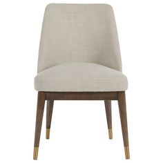 an upholstered chair with wooden legs and a light colored fabric seat padding