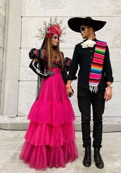 two people dressed up in costumes standing next to each other