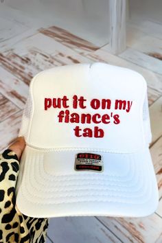 a white hat that says put it on my france's tab with red lettering