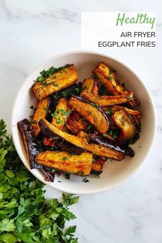 eggplant fries in a white bowl with parsley on the side and text healthy air fryer eggplant fries