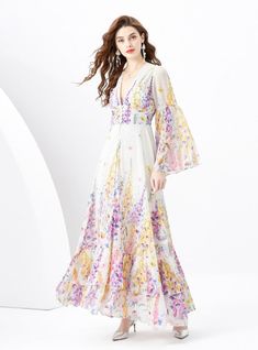 "Blossoming with the vibrant vitality of spring, this enchanting dress encapsulates the essence of a serene garden in full bloom. It’s a poetic sartorial choice for the romantic at heart, featuring a soft, flowing fabric adorned with delicate floral prints in a symphony of lilac, yellow, and pink hues. The deep V-neckline exudes a hint of allure, balanced by the full-length bishop sleeves that add a touch of bohemian elegance. Each tier of the skirt cascades gently to the ground, creating a silh Spring Wedding A-line Chiffon Dress, Spring Chiffon Beach Dress, Elegant A-line Chiffon Dress For Spring, Spring Feminine A-line Chiffon Dress, Spring Flowy Chiffon Dress, Flowy Chiffon Spring Dress, Feminine Spring Maxi Dress For Garden Party, Feminine Maxi Dress For Garden Party In Spring, Spring Chiffon Brunch Dress