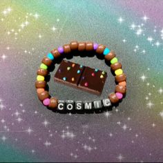 a candy bar bracelet with the word cosmic spelled out