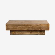 a wooden table top sitting on top of a white wall