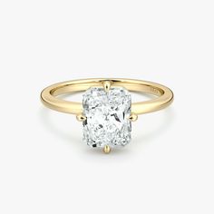 a cushion cut diamond engagement ring in yellow gold