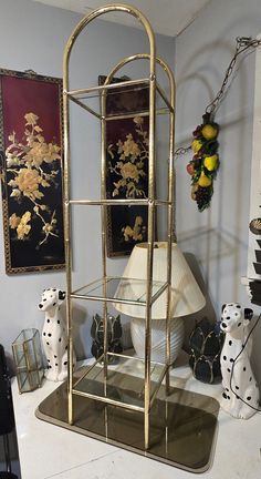 a metal shelf with two vases on top of it next to other decorative items