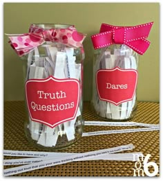 two jars with clothes pins in them and a pink bow on the top one is labeled truth questions