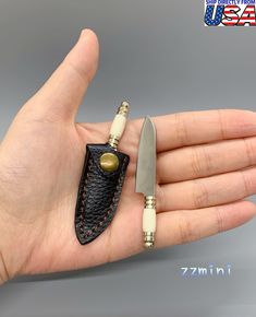 a hand holding a knife and some sort of pocket knife