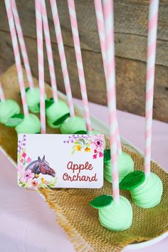 there are green and pink desserts on the table