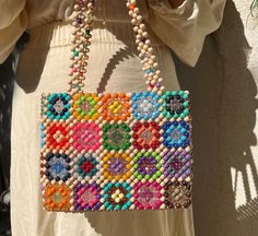 🌈 Handmade Colorful Granny Square Tote Beaded Bag 🌼 This unique tote beaded bag is lovingly crocheted with carefully selected colorful Granny Square motifs. Each pattern blends traditional craftsmanship with modern style to keep you looking chic and elegant at every step. 🎁 **Gift Recommendation This special bag makes an excellent gift choice for both young individuals and young-at-heart women, thanks to its colorful and fun design. It's a wonderful option to make special occasions or ordinar Granny Square Bag Handles, Bohemian Beaded Shoulder Bag For Vacation, Square Beaded Shoulder Bag For Beach, Bohemian Rectangular Bag With Colorful Beads, Multicolor Beaded Handheld Shoulder Bag, Elegant Multicolor Beaded Square Shoulder Bag, Elegant Multicolor Square Beaded Shoulder Bag, Multicolor Rectangular Bag With Colorful Beads, Multicolor Rectangular Shoulder Bag With Colorful Beads