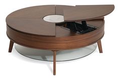 a coffee table with an open laptop on it's top and the bottom section missing