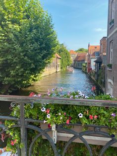 flowers are growing on the railings along the canal in brugein, france