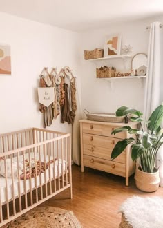 a baby's room with a crib, dresser and bed in the corner