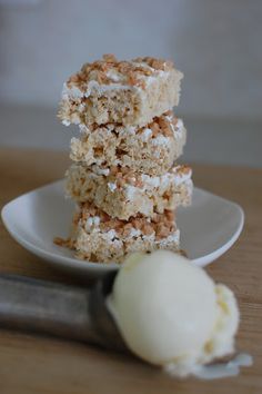 three pieces of cake sitting on top of a white plate next to a scoop of ice cream