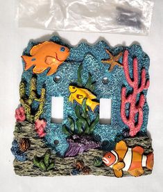 an outlet cover with fish and corals on it