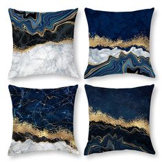 four pillows with gold and blue designs on them