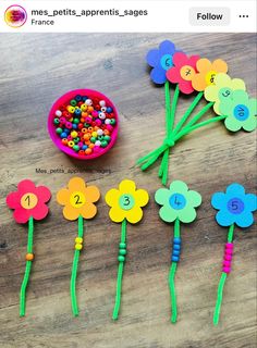 the flowers are made out of colored beads and plastic straws with numbers on them