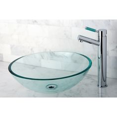 a glass bowl sink with chrome faucet and marble countertop in a bathroom