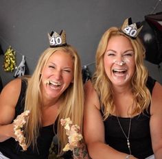 two women sitting next to each other with cake on their faces