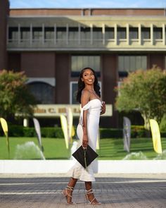 a woman in white is walking down the street