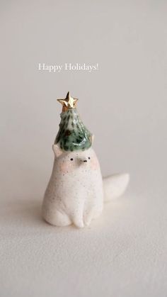 a white seal with a christmas tree on its head