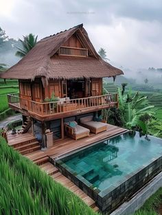 a house with a pool in the middle of some rice fields next to it is surrounded by greenery