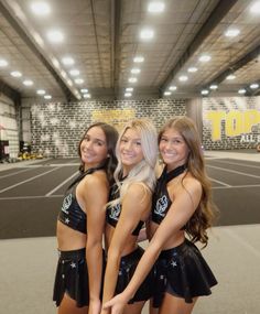 three beautiful young women standing next to each other in front of a basketball court with the words top ten written on it