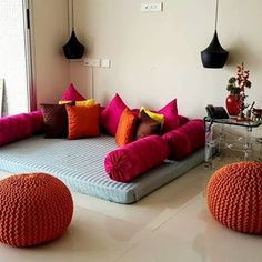 a living room filled with lots of colorful pillows