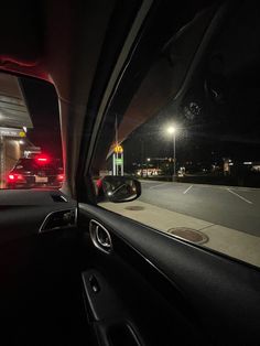 the interior of a car at night with its lights on and dashboard light turned red