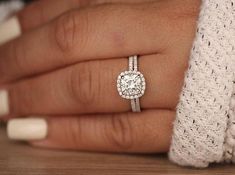 a woman's hand with a diamond ring on it