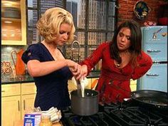 two women are cooking in the kitchen together