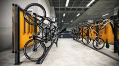 there are many bikes that are on the rack in this garage, and one is black