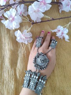 This beautiful oxidized Haath Phool is a part of Indian bridal jewelry. This Indian ethnic Haath Phool comes with an attached adjustable Ring Haatphools are back in fashion after a very long time and have returned with a bang. This piece of oxidised black polish haathphool consists of a bracelet & a rink which is joined by chains. This gives off a very elegant & royal look if you pair it up with any outfit. We generally see brides wearing haatphool & this piece of Indian jewelry is very occasion Adjustable Unique Design Jewelry For Festivals, Adjustable Jewelry With Unique Design For Festivals, Festival Jewelry With Unique Design And Adjustable Fit, Adjustable Oxidized Metal Jewelry, Antique Silver Bohemian Jewelry For Festivals, Bohemian Antique Silver Jewelry For Festivals, Antique Silver Jewelry With Intricate Design For Festival, Antique Silver Intricate Jewelry For Festival, Antique Silver Intricate Festival Jewelry