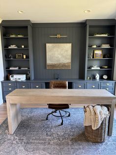 an office with built in bookcases and a large wooden desk on top of a rug