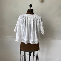 Hello and welcome to the Textile Trunk! Please follow us on Instagram , our user name is textiletrunk A fabulous rare find! Lace trimmed, GORGEOUS! his textile is a choir blouse dating from c 1900 or late 1800's. Made of crispy white cotton , This shirt was a Choir blouse and has lovely mends! ~ it was used and loved. There are some small stains on the back of one of the sleeves near the mends that would probably come out with some spot bleach work! I LOVE this blouse!! ( Eshirt 11094) MEASUREME Cotton Broderie Anglaise Cottagecore Tops, Cottagecore Cotton Tops With Broderie Anglaise, Cottagecore Broderie Anglaise Cotton Tops, Cotton Peasant Top With Lace Trim For Daywear, Cotton Tops With Crochet Trim For Daywear, Cotton Tops With Lace Trim For Daywear, Broderie Anglaise Cotton Lace Tops For Daywear, Vintage Cotton Blouse With Lace Cuffs, Bohemian Broderie Anglaise Tops For Daywear