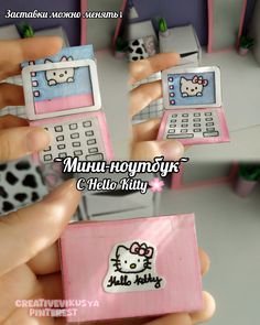 a person holding three cell phones with hello kitty stickers on them