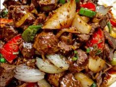 meat and vegetables are mixed together in a stir fry