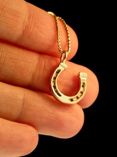 "Saddle up wearing this miniature, good-luck Horseshoe charm! It is cast in solid 14k gold and is 9/16\" in diameter. Wear just one or collect several of these darling horseshoe charms for a barrel full of good luck! The chain is not included in the price. If you would like a chain please select the stye and length from the option menu. If you would prefer a different style or length please contact us. This item usually ships the same or next business day. All Marty Magic Jewelry is packaged in 14k Yellow Gold Horseshoe Jewelry, 14-karat Yellow Gold Horseshoe Jewelry, Gold Engraved Horseshoe Jewelry, Horseshoe Necklace Gold, Good Luck Horseshoe, Dragon Logo, Magic Dragon, Magic Jewelry, Lucky Charm Necklace