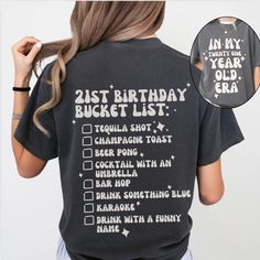 a woman wearing a 21st birthday bucket list t - shirt with her back to the camera