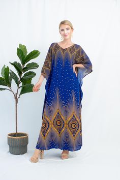 Our Bohemian Beach Party Dress is the perfect addition to your summer wardrobe. Made with soft cotton and featured peacock prints, this comfortable kaftan is designed to provide maximum comfort while still being stylish and trendy. The plus size cut is perfect for women of all sizes and shapes, so you can feel confident and beautiful no matter where you go. Personalized on length and size is free of charge! FEATURES - Blue - Peacock - Personal Custom Made - Full Length Kaftan Long Sleeves - Cott Blue Printed Maxi Beach Dress, Blue Floor-length Maxi Dress For Beach Cover-up, Blue Floor-length Maxi Dress For Beach, Blue Free Size Maxi Dress, Blue Printed Kaftan With Kimono Sleeves, Blue Boho Print Kaftan For Vacation, Blue Boho Print Tunic Maxi Dress, Long Blue Printed Beach Dress, Blue Boho Print Maxi Dress