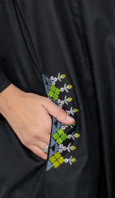 a close up of a person's hand holding an object in their pocket