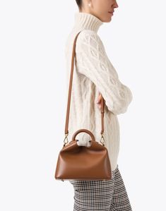 Inspired by the shape of Chinese dumplings, Elleme's Baozi bag is beloved by tastemakers and customers alike. The sculpted leather silhouette features a circular top handle and a detachable crossbody strap, perfect for day-to-night styling. Carry it with your favorite dresses and separates for a variety of polished ensembles. Everyday Brown Satchel With Round Handle, Brown Modern Satchel With Adjustable Handle, Modern Brown Satchel With Adjustable Handle, Cognac Top Handle Satchel For Fall, Fall Cognac Top Handle Satchel, Chic Brown Satchel With Round Handle, Fall Satchel With Detachable Strap And Top Handle, Fall Top Handle Satchel With Detachable Strap, Brown Satchel With Top Carry And Round Handle