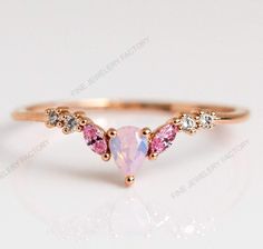 The sweetest stacker.  With its pink opal and light pink CZ's, we especially love the Sweet Like Honey Ring paired with  opal to create a pastel dream stack.Natural Pink Opal Ring, Vintage Opal Band, Opal Wedding Band, Rose Gold Opal Ring, Dainty Opal Ring, October Birthstone, Matching Band Ring Item Details Metal: 925 Sterling Silver Main stone creation-Opal  (lab created) Main Stone Color: Pink Main Stone Shape: Pear Cutting technique-  Cut Theme: Dainty, Statement & Engagement Method: handmade Personalization: Possible Occasion: Wedding ring, engagement ring, birthday ring, ring for her, proposal ring Style: Ring Size: We make rings from US 4 to US 15. (If you need smaller or bigger ring size, please ask me to resize) Country of Manufacture: India All our work is custom made by hand wit Eclectic Rings, Angel Rings, Sweet Like Honey, Gold Opal Ring, Pink Opal Ring, Opal Ring Vintage, Angel Ring, Rose Gold Opal Ring, Australian Opal Ring