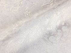 an image of a white textured background that looks like it has been painted with metallic foil