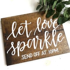 a wooden sign that says let love sparkle send off at 10pm