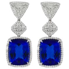 Exquisite, one-of-a-kind rare color Tanzanite and diamond earrings set with all GIA Certified Diamonds. 33.79 Carats of Cushion Cut Tanzanites, (16.89 Carats and 16.90 Carats) with very Rare Violetish Blue color. Set with two GIA Certified Asscher Cut diamonds totaling 2.62 Carats (1.32 Carats I - VS2 and 1.30 Carats I - VS2) And two GIA Certified Trillions totaling 3.06 Carats. Surrounded by 1.77 Carats of pave round brilliant cut diamonds. A stunning breathtaking piece of jewelry~ White Diamond Jewelry, Formal Earrings, Blue Statement Necklace, Vintage Drop Earrings, Tanzanite Jewelry, Platinum Earrings, Ruby Wedding, Asscher Cut Diamond