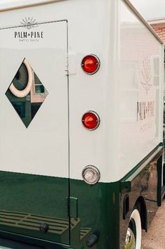 a green and white truck parked in a parking lot