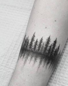 a black and white photo of trees on the arm, with dots in the middle