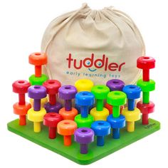 a bag filled with colorful wooden pegs next to an assortment of colored plastic toys